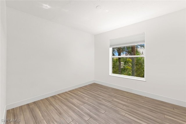 empty room with light hardwood / wood-style flooring