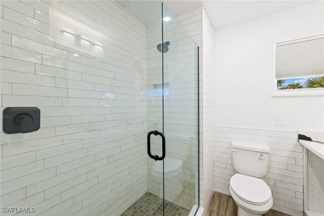 838-840 Rabbit Rd, Sanibel, FL 33957 - bathroom featuring a shower stall, tile walls, a wainscoted wall, toilet, and vanity
