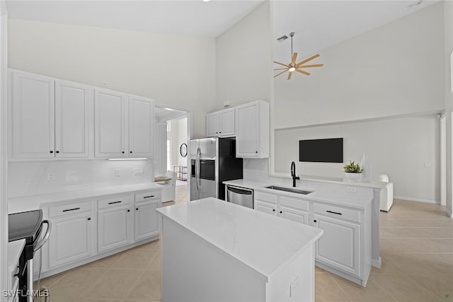 kitchen with a center island, sink, kitchen peninsula, and white cabinets