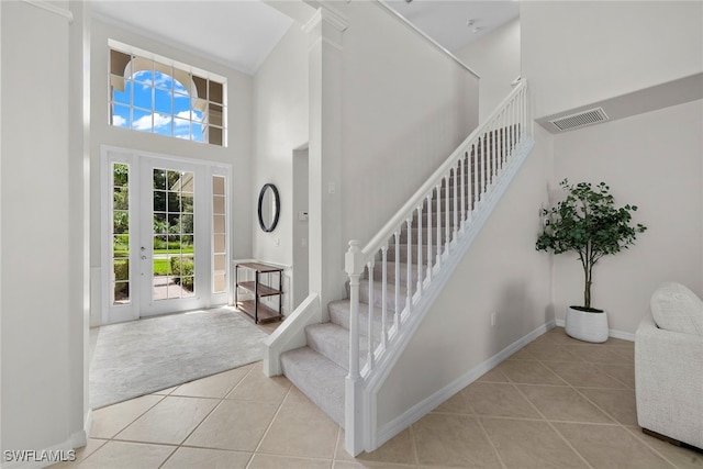 foyer entrance featuring a high ceiling and light tile patterned floors