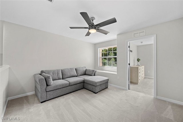 living room featuring light colored carpet and ceiling fan