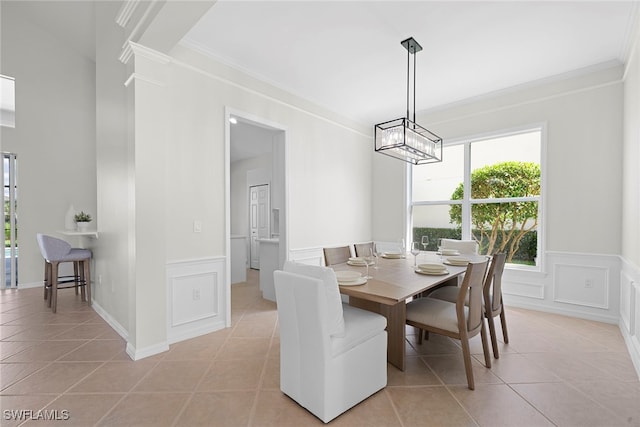 dining area with ornamental molding and light tile patterned floors