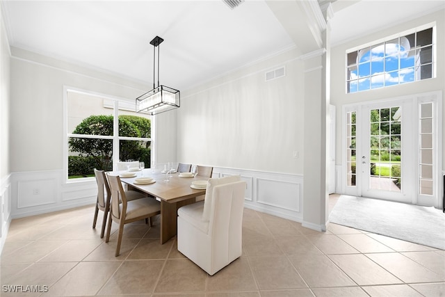 tiled dining area featuring ornamental molding