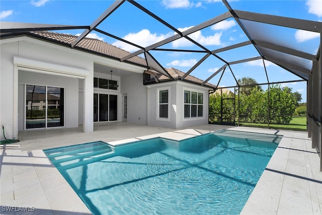 view of pool with a patio area, a lanai, and ceiling fan