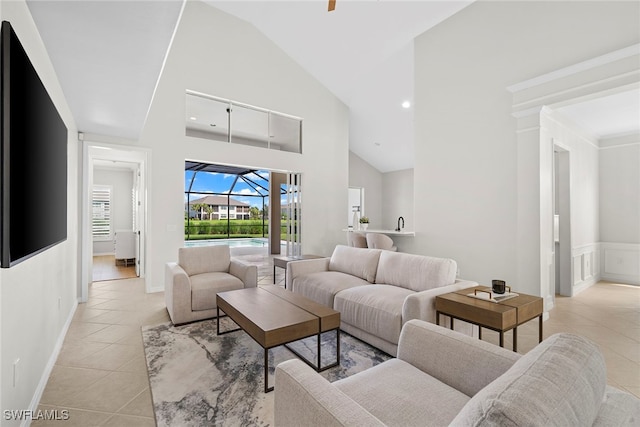 living room featuring high vaulted ceiling and light tile patterned floors