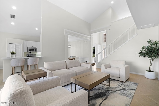 living room featuring high vaulted ceiling and light tile patterned floors