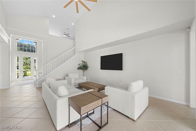 tiled living room with high vaulted ceiling and ceiling fan