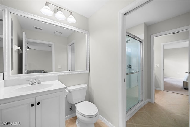 bathroom with toilet, tile patterned flooring, a shower with shower door, vanity, and ceiling fan