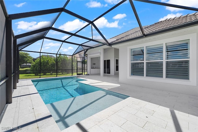 view of swimming pool with a patio and glass enclosure