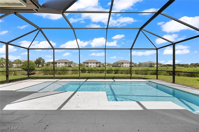 view of swimming pool with a patio area and glass enclosure