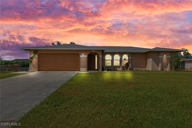 view of front of house featuring a lawn and a garage