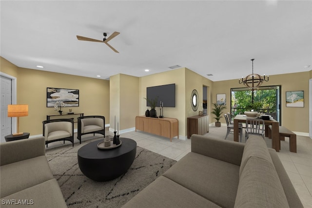 tiled living room featuring ceiling fan with notable chandelier