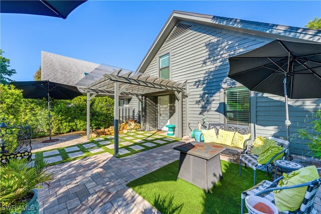 back of property featuring a pergola, a patio, a lawn, and an outdoor hangout area