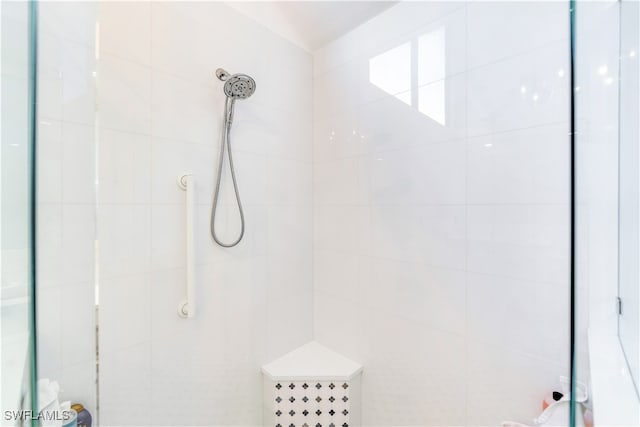 bathroom with tiled shower