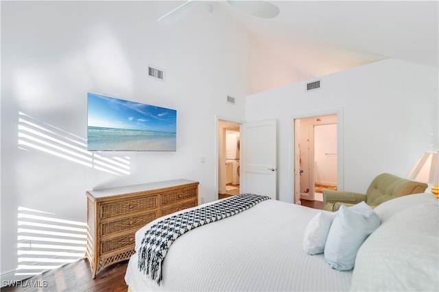 bedroom with dark wood-type flooring, high vaulted ceiling, connected bathroom, and ceiling fan