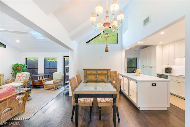 dining room with lofted ceiling, dark hardwood / wood-style floors, and an inviting chandelier