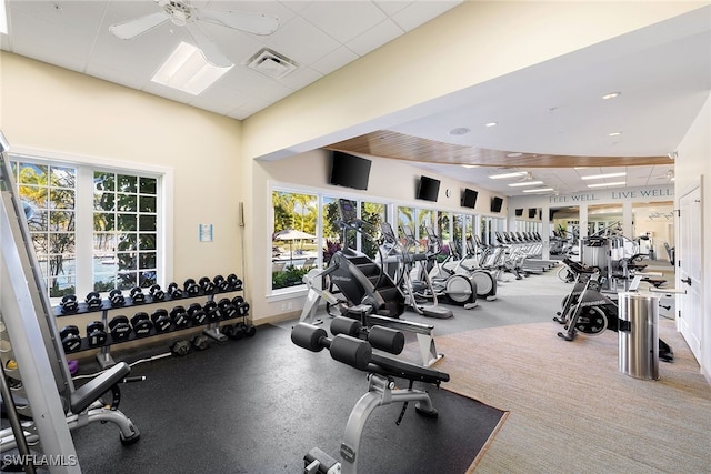 gym with a drop ceiling and ceiling fan