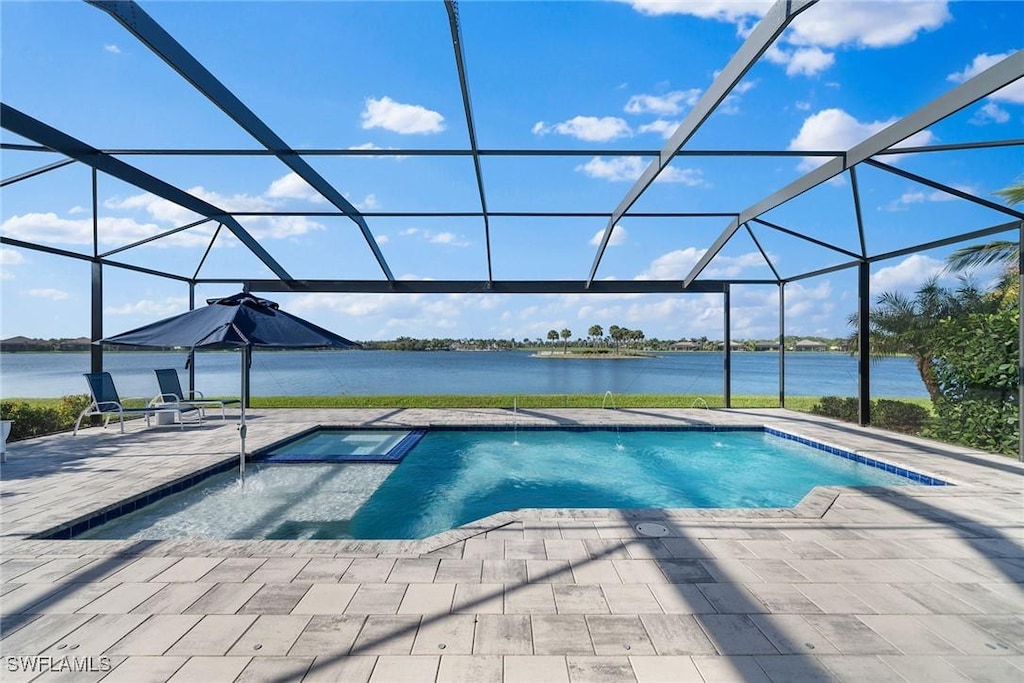 view of swimming pool featuring a water view, glass enclosure, and a patio area