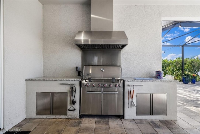 view of patio featuring an outdoor kitchen and a lanai