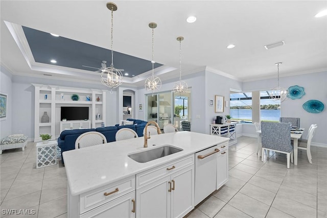 kitchen featuring sink, a chandelier, white dishwasher, a raised ceiling, and white cabinets