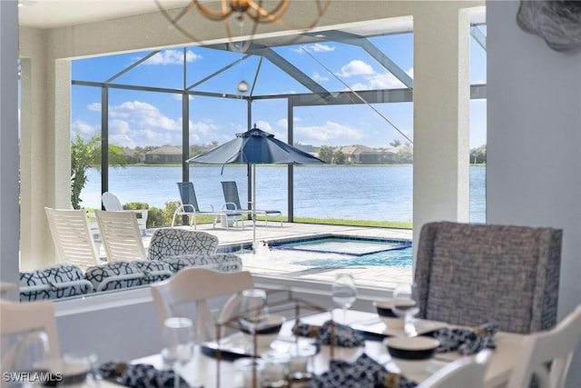 view of pool featuring a hot tub, a patio, a water view, and a lanai