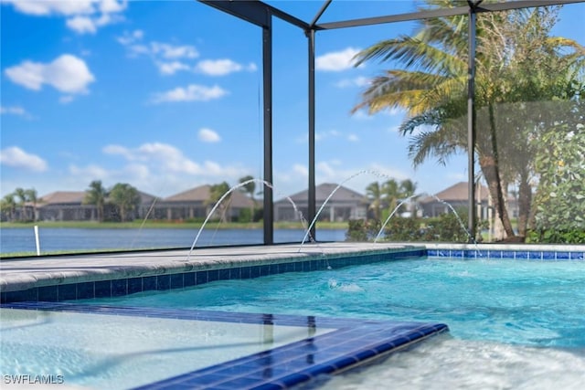 view of swimming pool with a lanai, pool water feature, and a water view