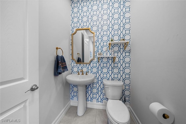 bathroom featuring tile patterned flooring and toilet