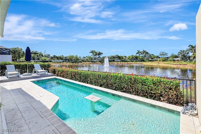 view of pool with a patio area and a water view