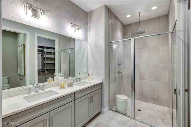 bathroom featuring walk in shower, vanity, and toilet