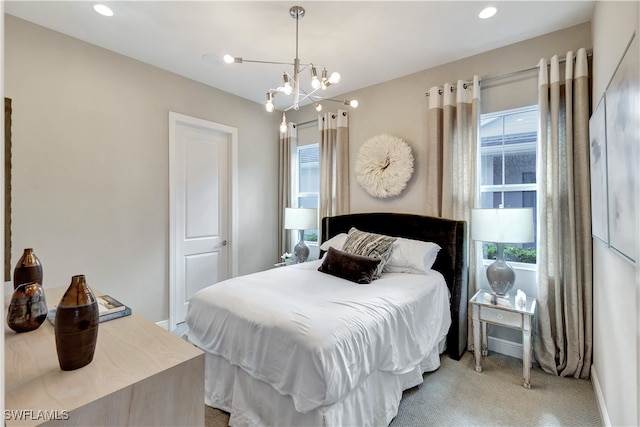 carpeted bedroom featuring a chandelier and multiple windows