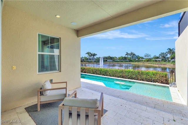 view of swimming pool featuring a water view