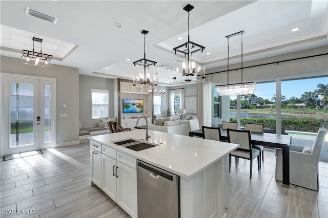 kitchen with dishwasher, pendant lighting, a raised ceiling, and sink