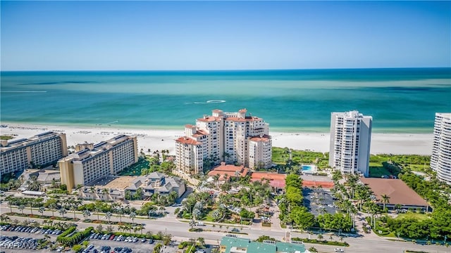 birds eye view of property featuring a water view and a beach view