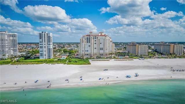 drone / aerial view featuring a beach view and a water view