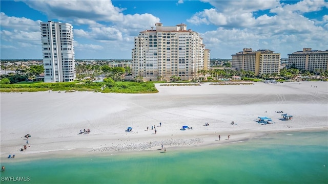 drone / aerial view featuring a view of the beach and a water view