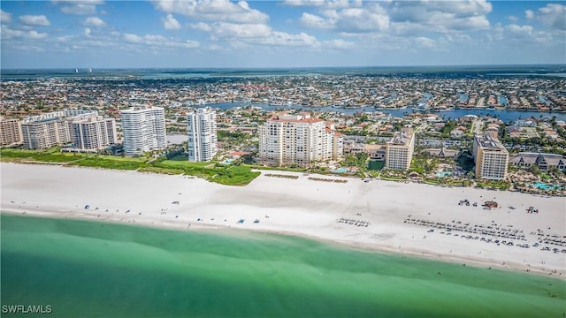 drone / aerial view with a water view and a beach view