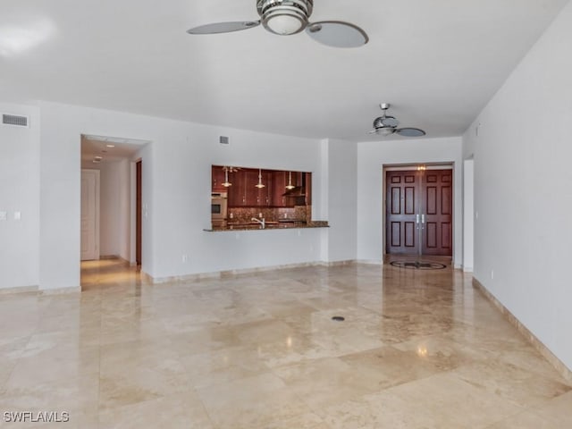 unfurnished living room featuring ceiling fan