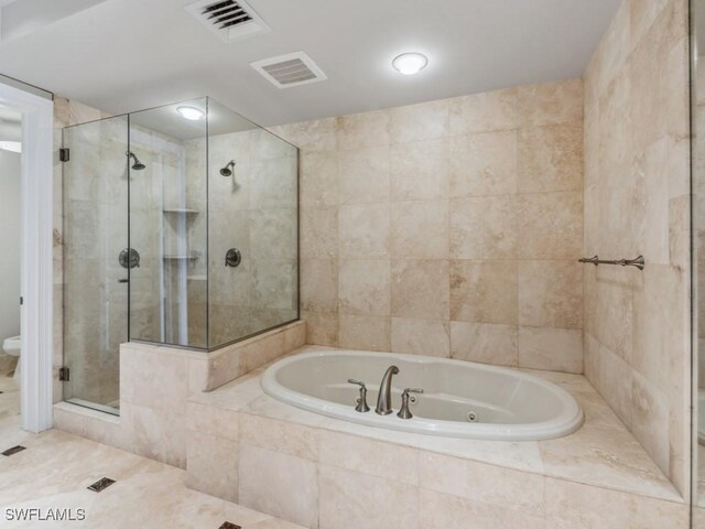 bathroom featuring shower with separate bathtub