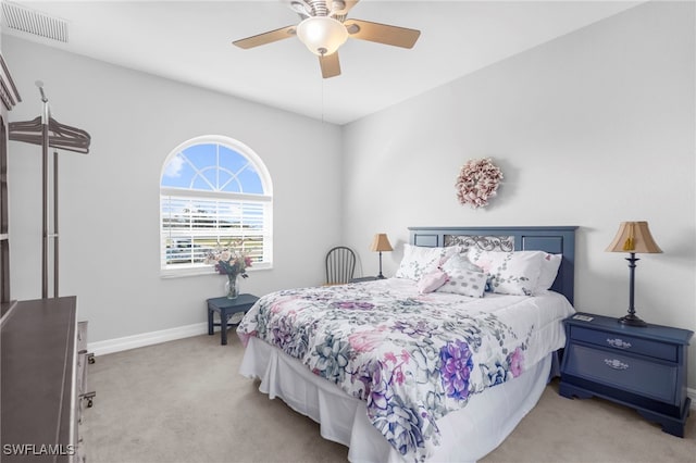 bedroom featuring light carpet and ceiling fan