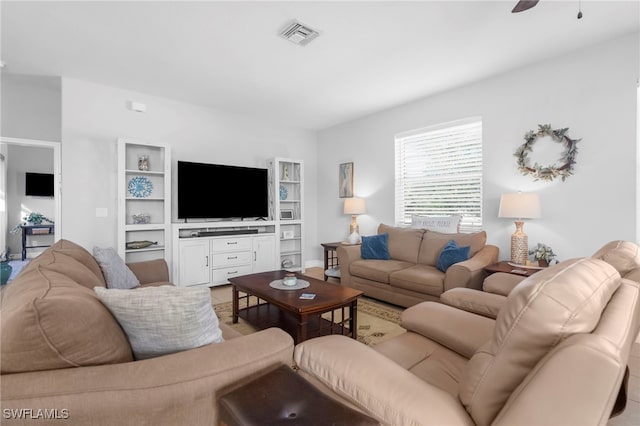 living room with hardwood / wood-style flooring and ceiling fan