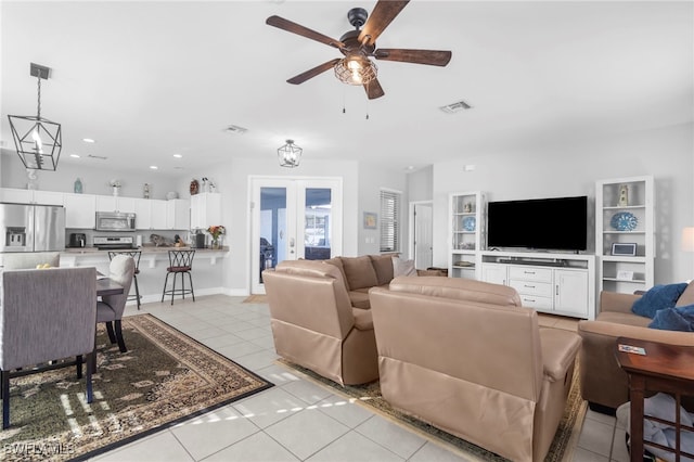 living room featuring french doors, ceiling fan, and light tile patterned flooring