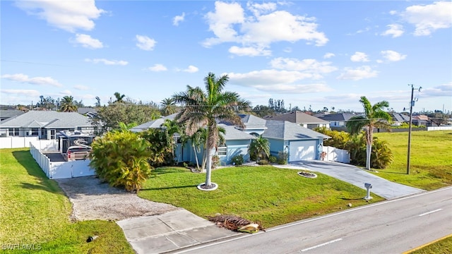 view of front of house featuring a front lawn and a garage