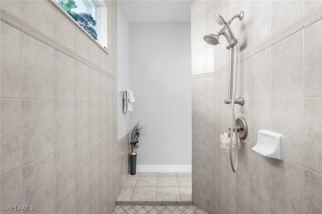 bathroom with tile patterned flooring and tiled shower