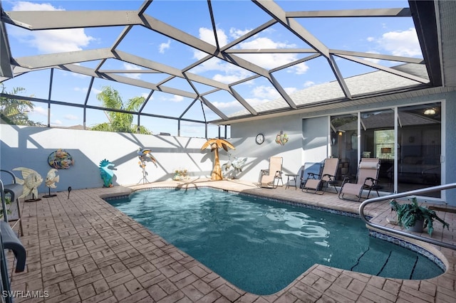 view of pool with a patio and a lanai