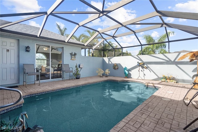 view of swimming pool with a patio area and glass enclosure