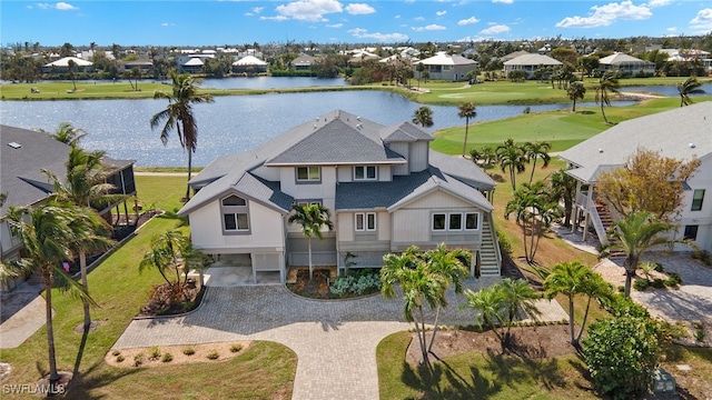 birds eye view of property with a water view