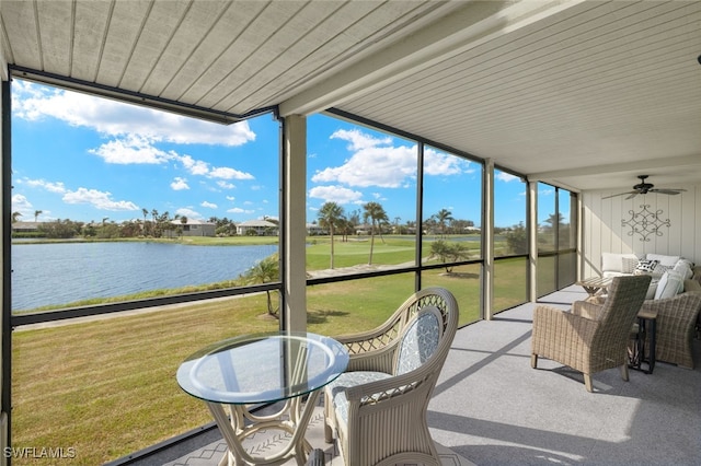 sunroom / solarium with a water view and ceiling fan