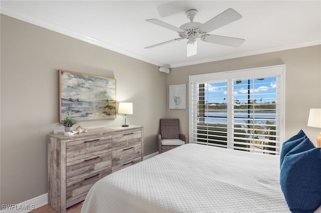 bedroom with ornamental molding, hardwood / wood-style floors, a water view, and ceiling fan