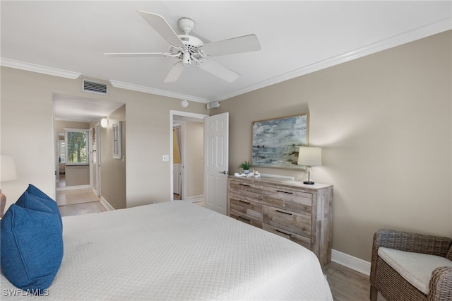 bedroom featuring crown molding, light wood-type flooring, and ceiling fan