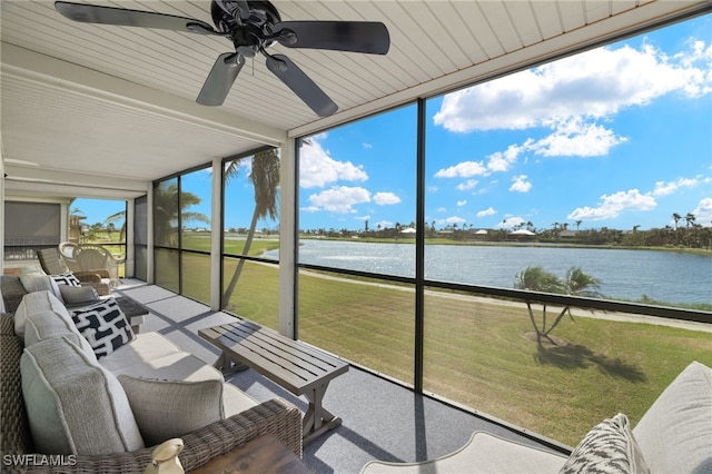 sunroom / solarium featuring a water view and ceiling fan